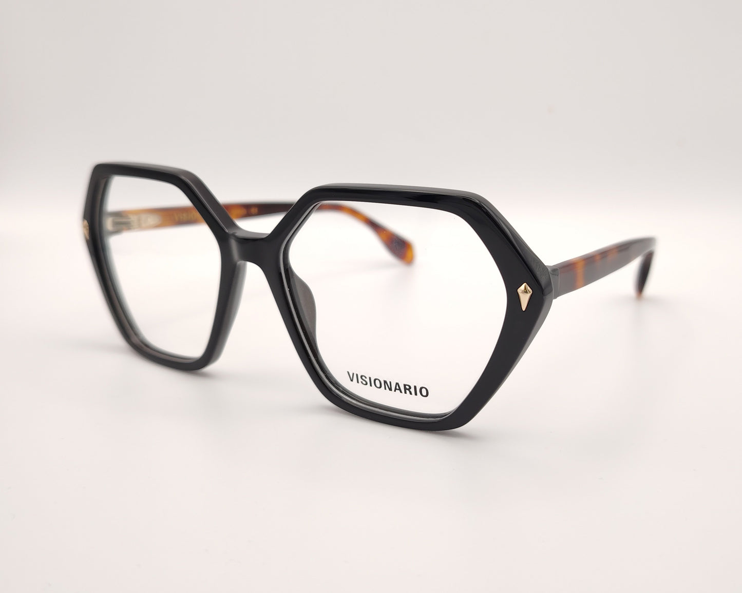 gafas con forma hexagonal y frontal negro con varillas en carey ámbar marca visionario