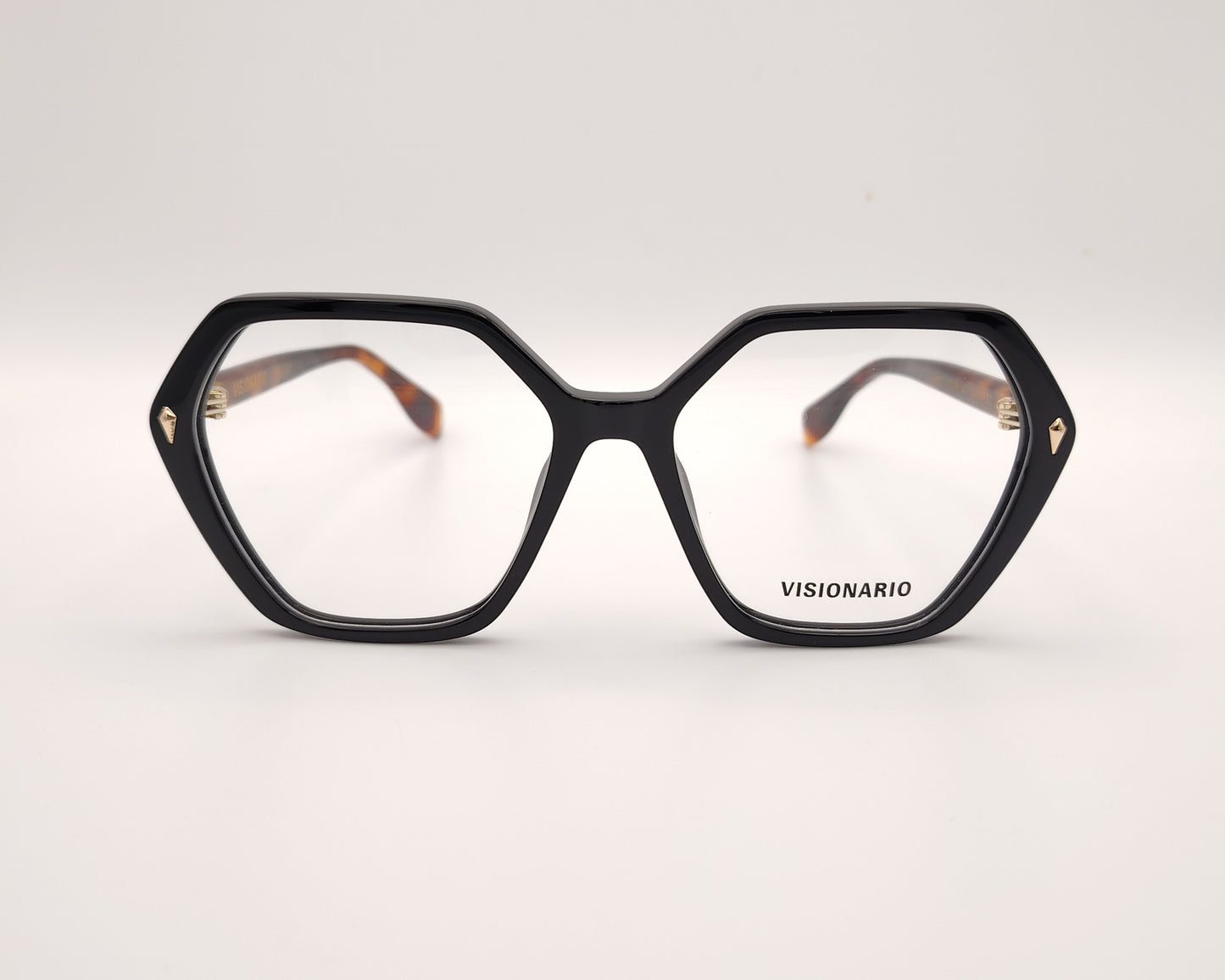 gafas con forma hexagonal y frontal negro con varillas en carey ámbar marca visionario