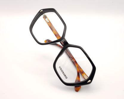 gafas con forma hexagonal y frontal negro con varillas en carey ámbar marca visionario
