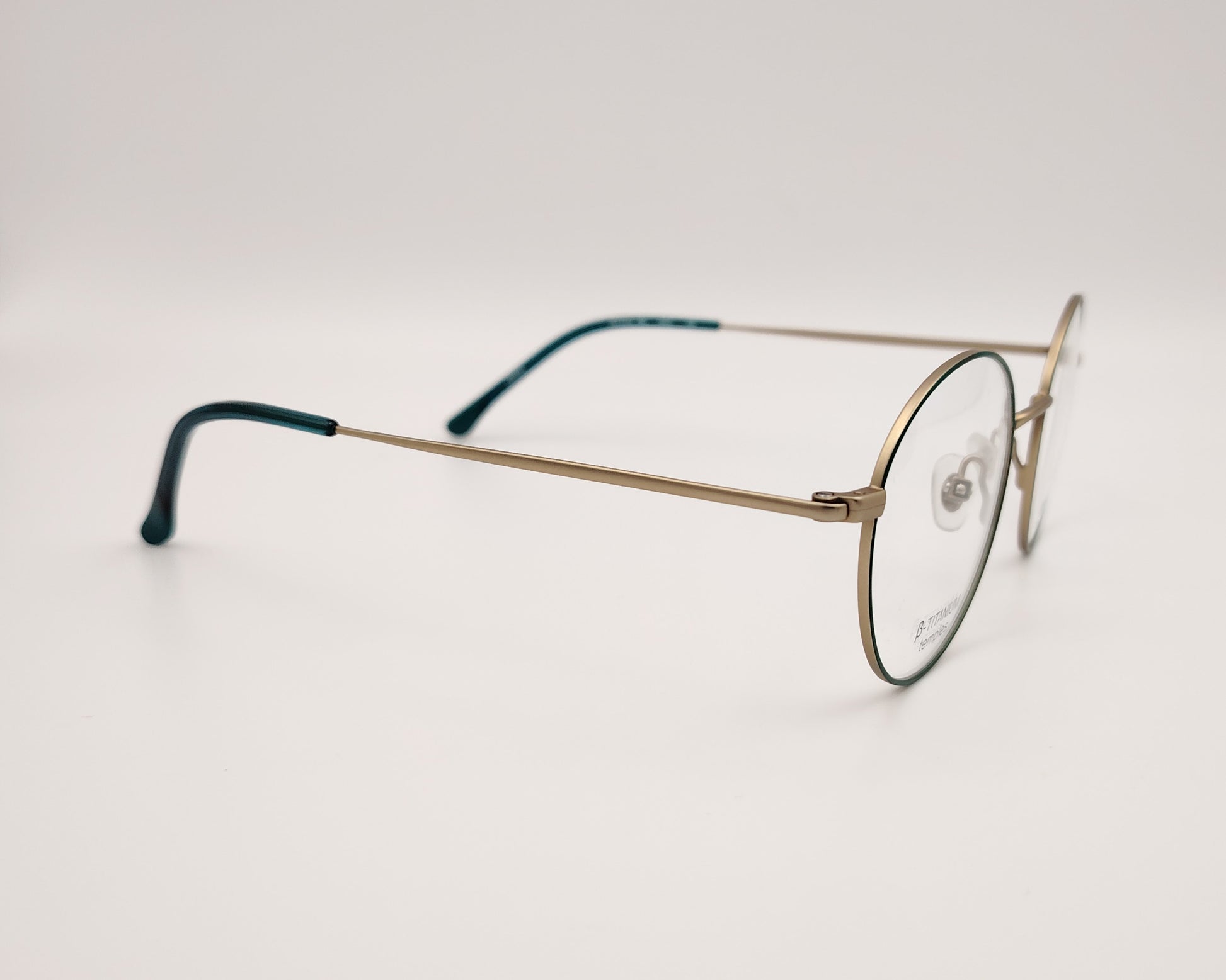 gafas woodys alix 03 de titanio dorado con lacado verde y forma redonda 