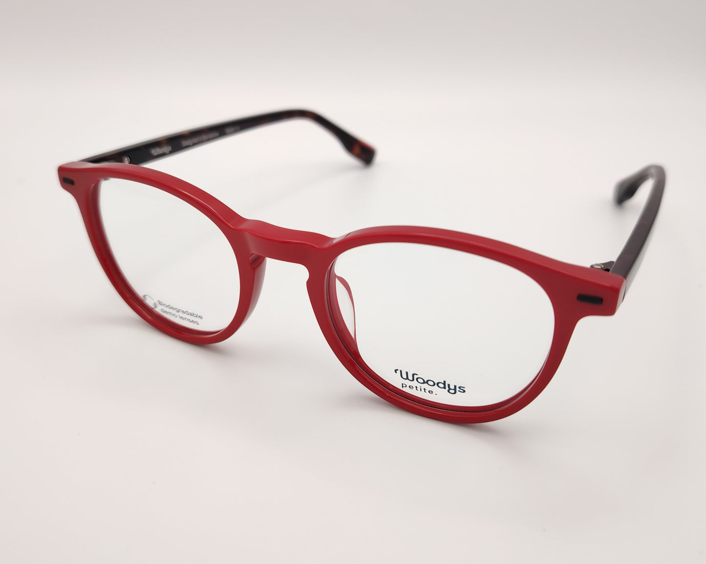 gafas graduadas woodys flynn 04 con montura de acetato en color rojo diseño redondeado con puente keyhole y varillas en carey  que aportan contraste sutil estilo moderno y juvenil con un ajuste cómodo