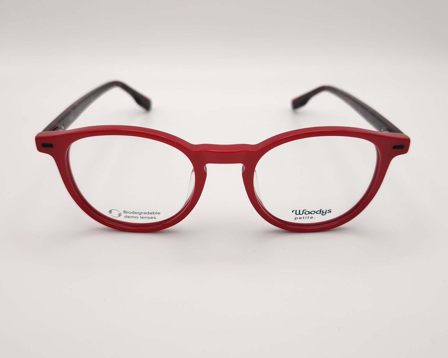 gafas graduadas woodys flynn 04 con montura de acetato en color rojo diseño redondeado con puente keyhole y varillas en carey  que aportan contraste sutil estilo moderno y juvenil con un ajuste cómodo