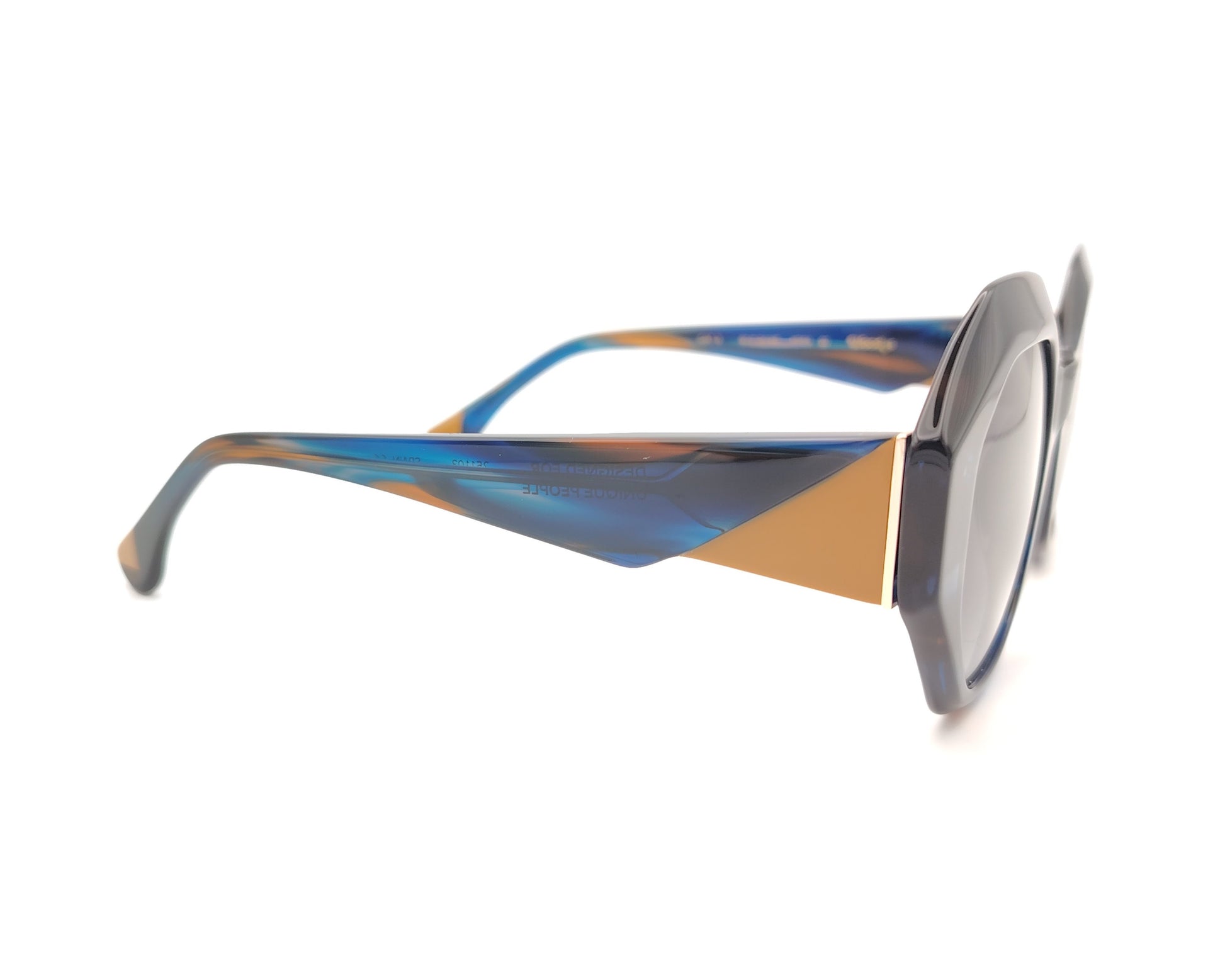 gafas de sol oversize geometricas en acetato azul marmoleado con lentes gris degradado y varillas en contraste miel