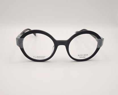 gafas woodys kiss 01 montura de acetato redonda negra detalles geométricos blanco y negro diseño elegante y moderno
