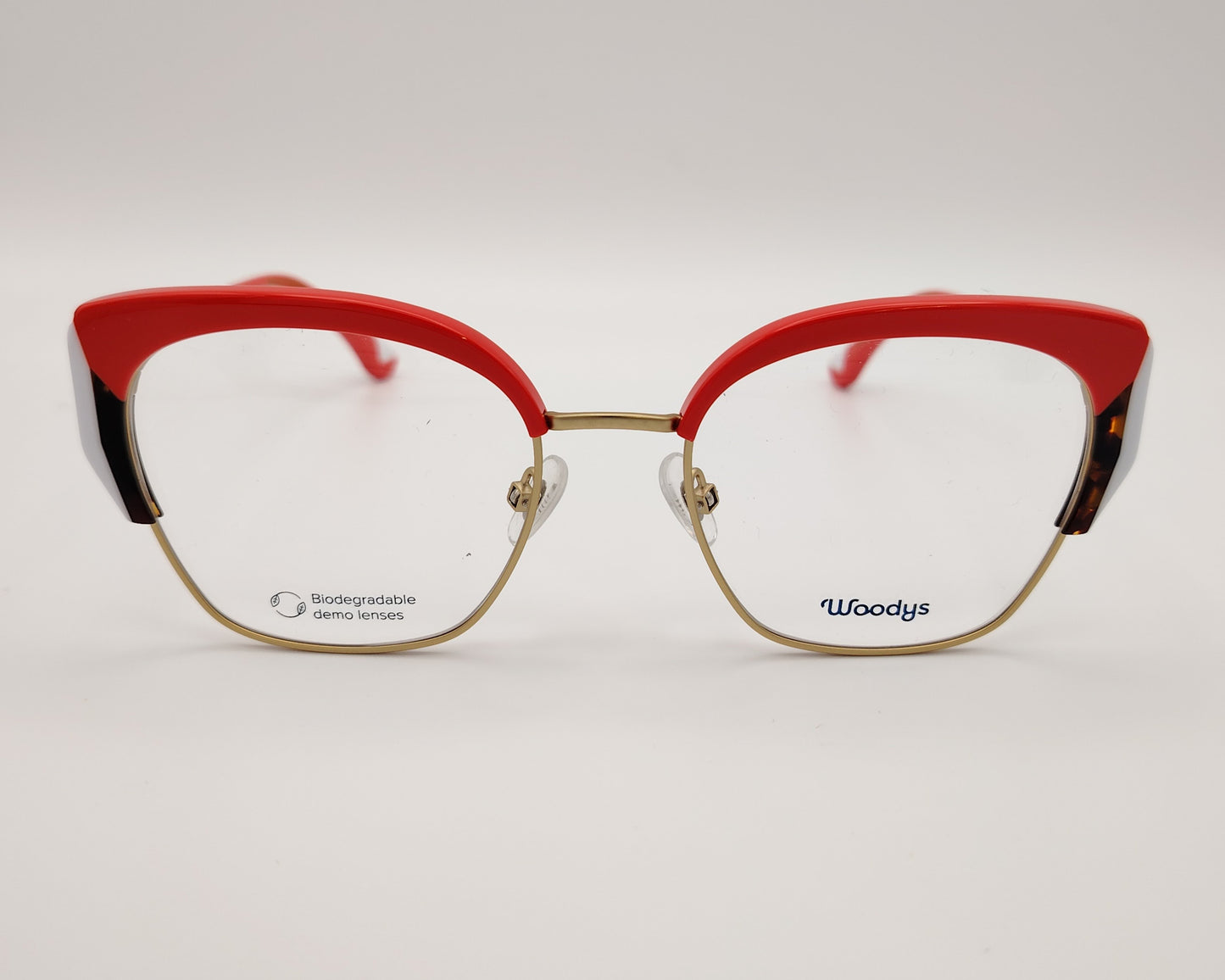 gafas graduadas woodys sinclair 04 con montura metálica dorada diseño cat eye con parte superior en acetato rojo detalles en blanco y habana en las esquinas varillas doradas con terminales en rojo estilo elegante y llamativo