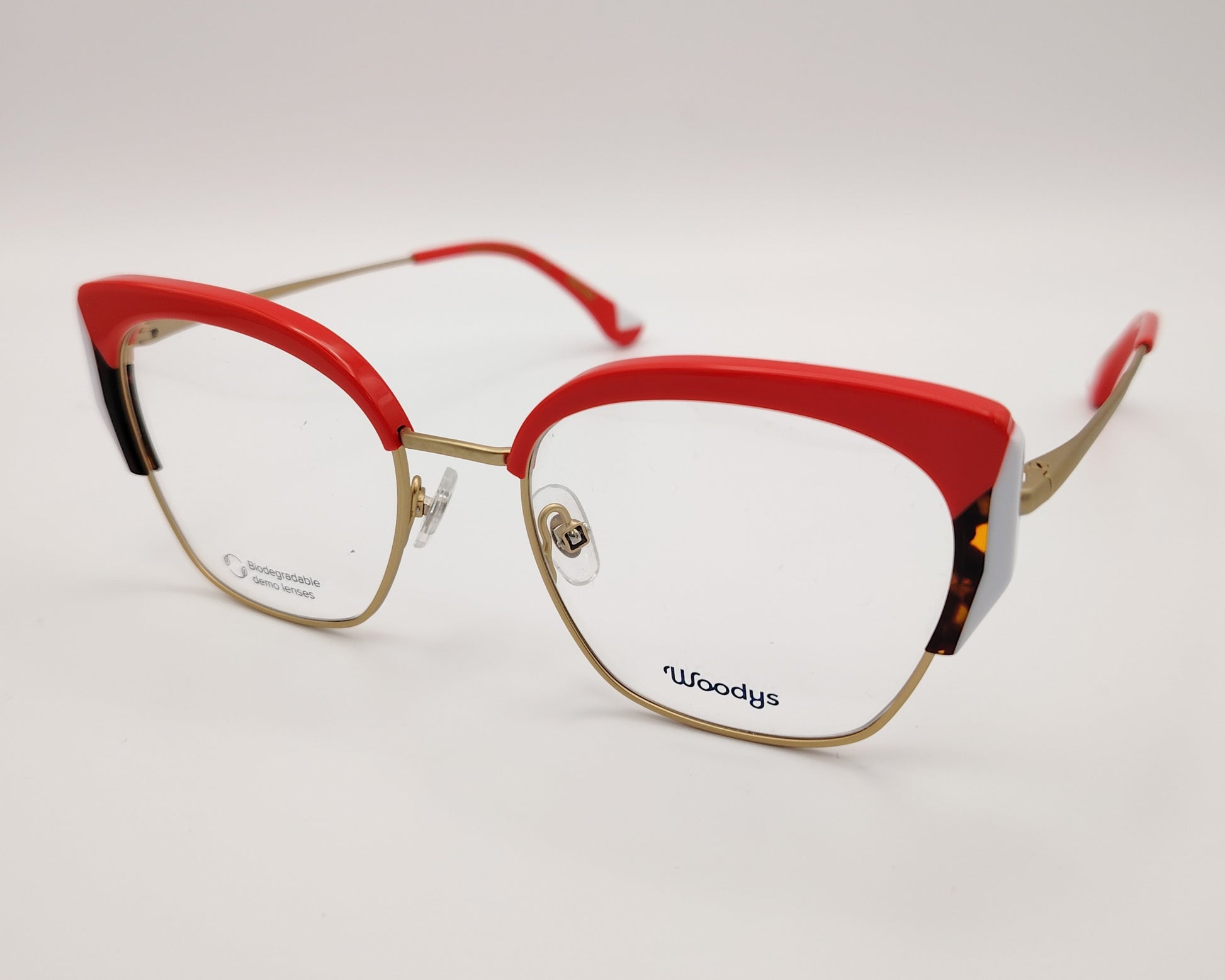 gafas graduadas woodys sinclair 04 con montura metálica dorada diseño cat eye con parte superior en acetato rojo detalles en blanco y habana en las esquinas varillas doradas con terminales en rojo estilo elegante y llamativo