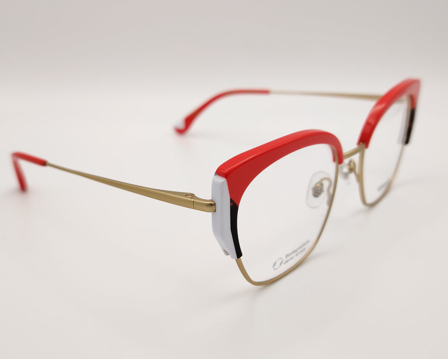 gafas graduadas woodys sinclair 04 con montura metálica dorada diseño cat eye con parte superior en acetato rojo detalles en blanco y habana en las esquinas varillas doradas con terminales en rojo estilo elegante y llamativo